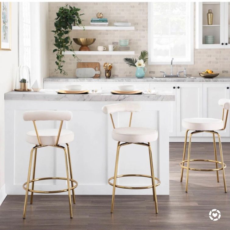 Elegant white kitchen with gold counter stools