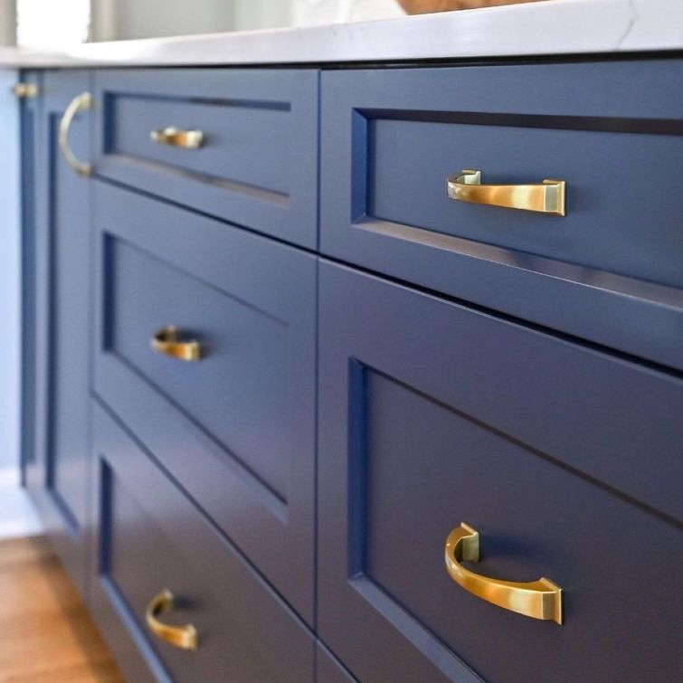 Navy blue kitchen cabinets with gold hardware