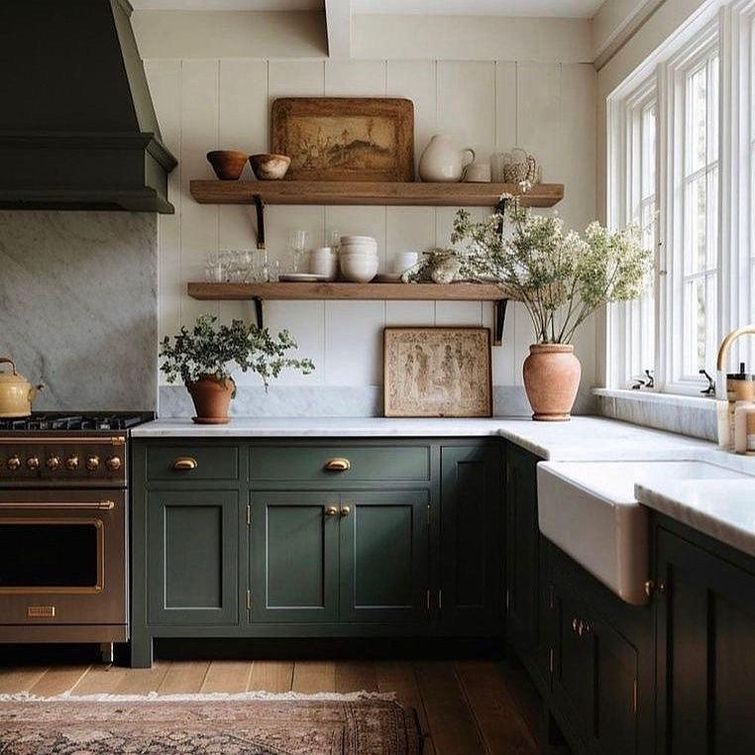 rustic kitchen with green cabinets and terracotta accents