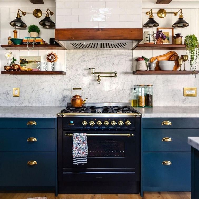 Navy blue kitchen cabinets with gold styled cooker