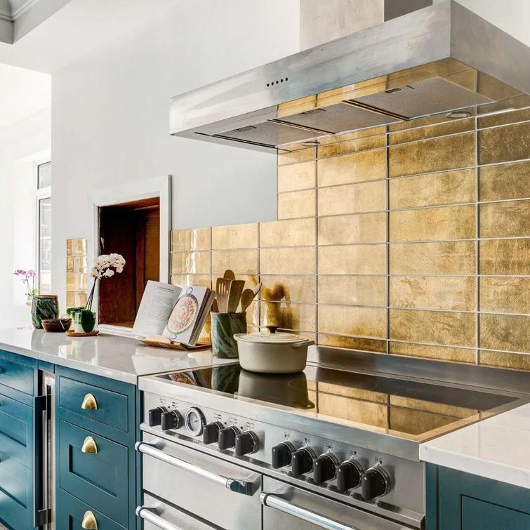 Teal blue-green kitchen cabinets with gold accents