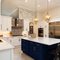 Navy lowers or a navy island with white uppers is the safest bold kitchen. Here's how to match the blue to your room's light and bulbs, pick the uppers and counters, and choose the metal.