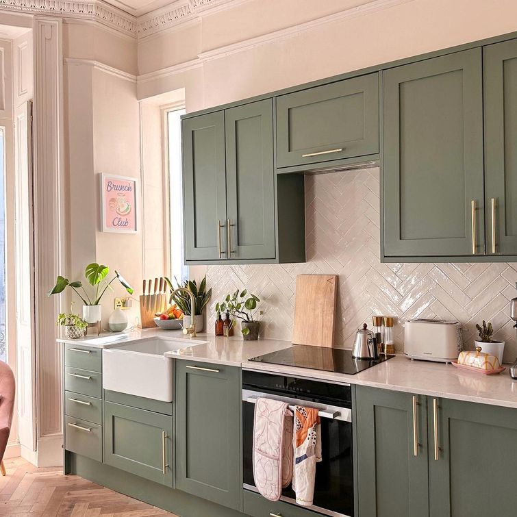 Woman struggling to reach top kitchen cabinet