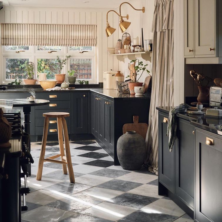 Renovated kitchen with green cabinets and gold accents