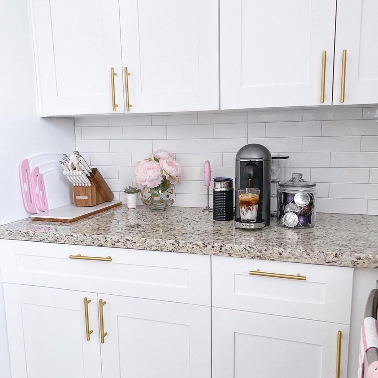 White kitchen cabinets with golden accents