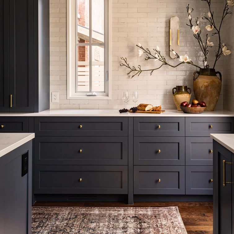 Glossy subway tile kitchen with dark blue millwork